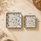 Two square decorative plates with a blue floral pattern on a cream background, shown with dimension labels indicating 20 cm by 20 cm and 15.5 cm by 15.