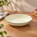 Round ceramic Cove Serving Bowl with concentric detailing in a warm ivory finish.
