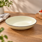 Round ceramic Cove Serving Bowl with concentric detailing in a warm ivory finish.
