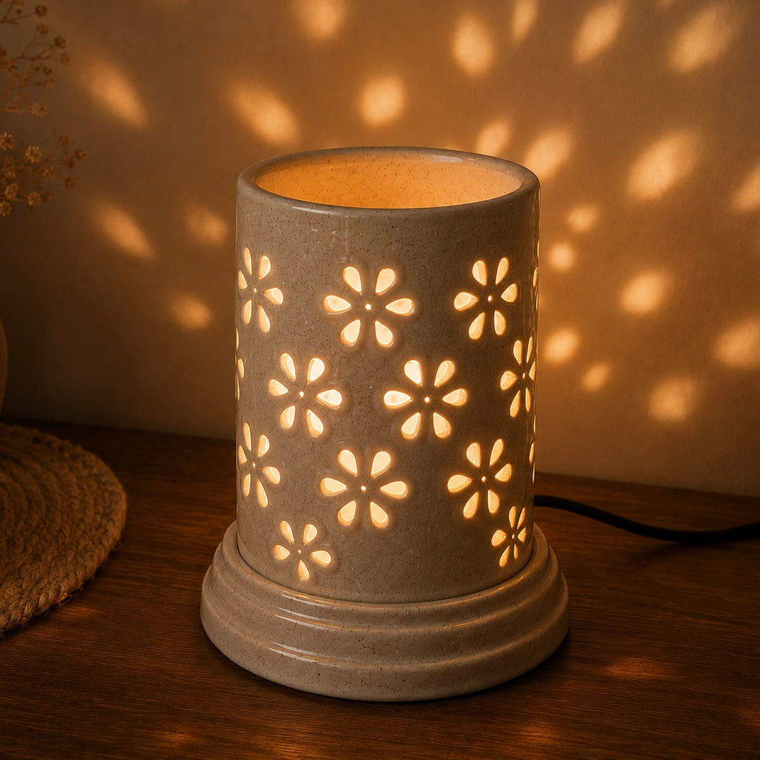 Large ceramic aroma lamp by Ozay Living with elegant floral cut-out design for essential oils and wax melts.