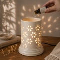 Large ceramic aroma lamp by Ozay Living with elegant floral cut-out design for essential oils and wax melts.