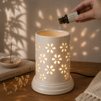 Large ceramic aroma lamp by Ozay Living with elegant floral cut-out design for essential oils and wax melts.