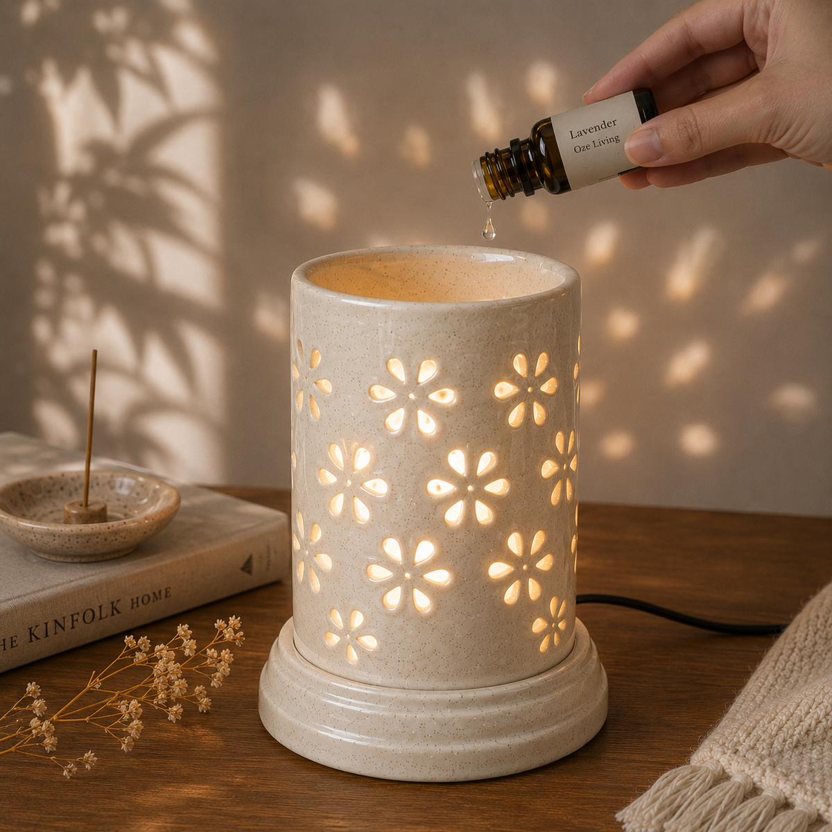Large ceramic aroma lamp by Ozay Living with elegant floral cut-out design for essential oils and wax melts.