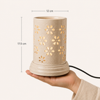 Large ceramic aroma lamp by Ozay Living with elegant floral cut-out design for essential oils and wax melts.