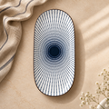 Oval ceramic Kyoto Serving Platter by Ozay Living featuring a Japanese-inspired indigo radial pattern.