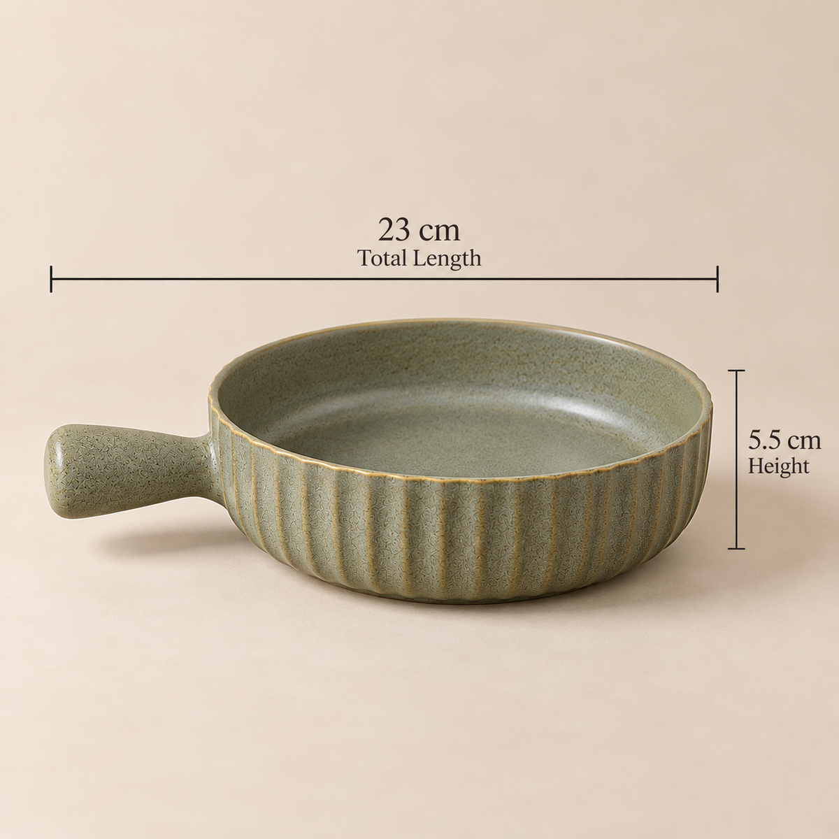 A small round ceramic pan with a handle, shown on a plain beige background with overlaid dimension lines and text indicating 23 cm total length and 5.5 cm height.
