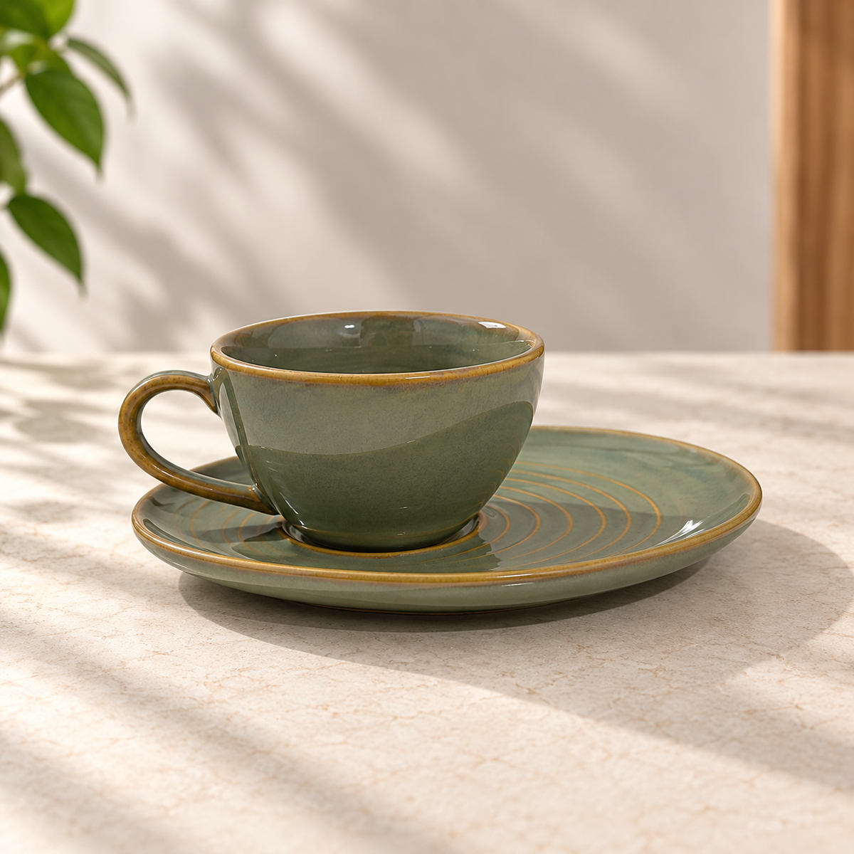 Olive Orbit Cup & Saucer Set in ceramic with earthy olive glaze by Ozay Living