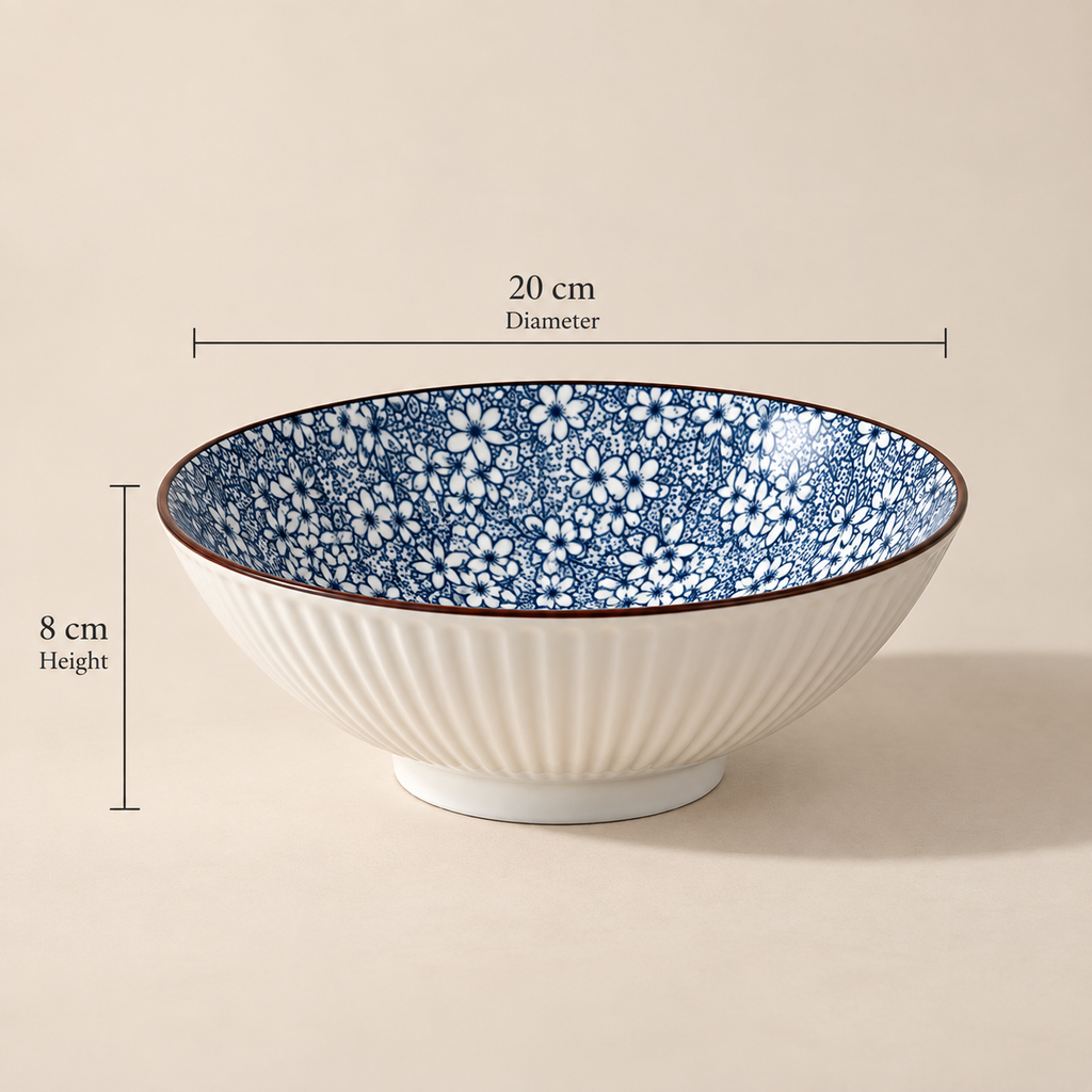 Round ceramic Sakura Serving Bowl featuring a delicate blue cherry blossom-inspired floral pattern.