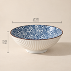 Round ceramic Sakura Serving Bowl featuring a delicate blue cherry blossom-inspired floral pattern.