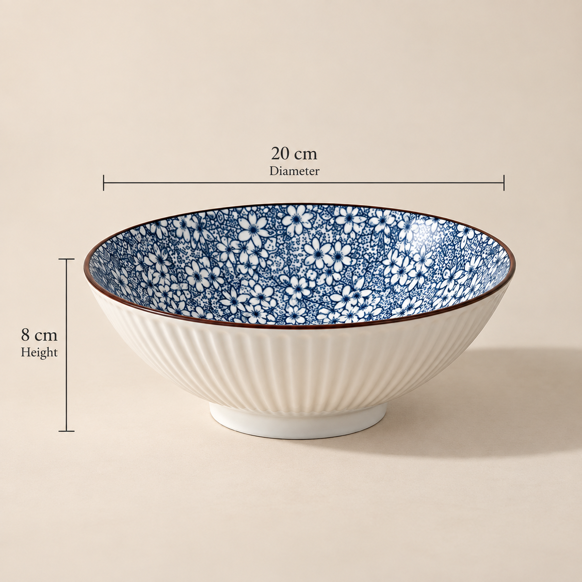 Round ceramic Sakura Serving Bowl featuring a delicate blue cherry blossom-inspired floral pattern.