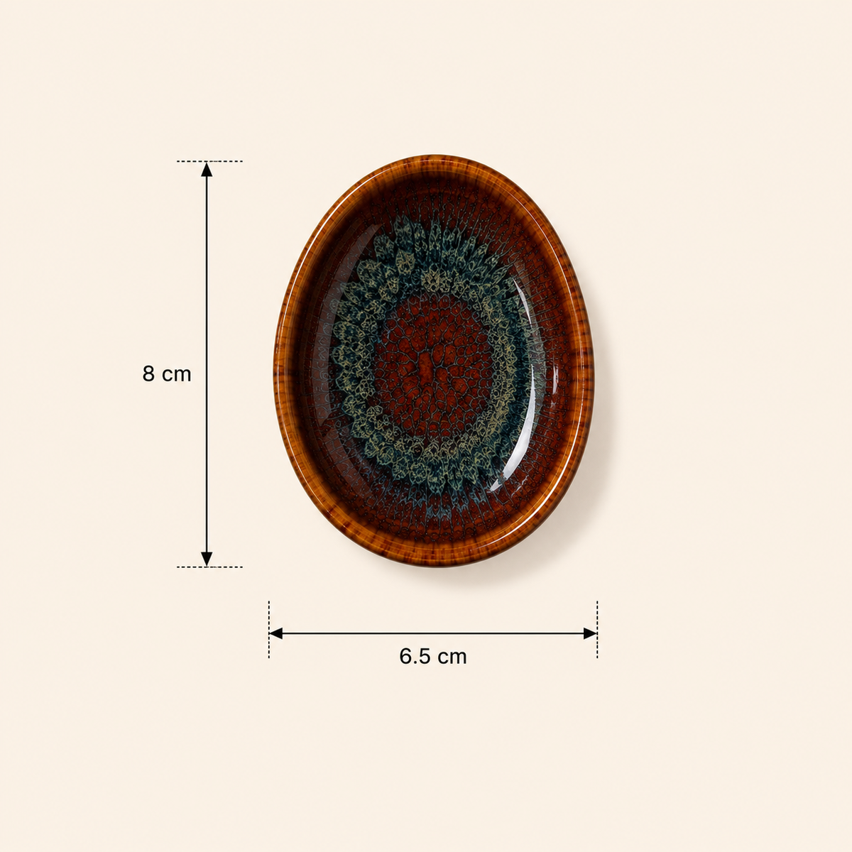 Ceramic Amber Tide Petite Server  with a glossy brown rim and a detailed teal and red mandala pattern in the center, shown with dimension lines indicating 8 cm height and 6.5 cm width on a light beige background.