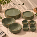 A 14-piece ceramic dinnerware set by Ozay living in a muted sage green color with a thin gold-toned rim, arranged on a beige tablecloth with natural leaf shadows. The set includes plates, bowls, and katoris, with text labels pointing to each component.