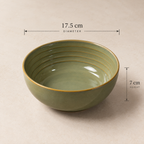 An olive green Grove Serving Bowl by OZAY Living with gold-toned ridges and rim, shown on a beige background with dimension overlays indicating a diameter of 17.5 cm and height of 7 cm.