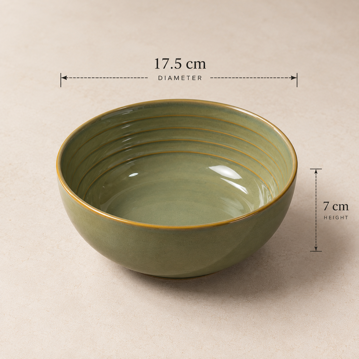 An olive green Grove Serving Bowl by OZAY Living with gold-toned ridges and rim, shown on a beige background with dimension overlays indicating a diameter of 17.5 cm and height of 7 cm.