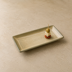 
Sand Stone Serving Platter by OZAY Living styled on a dining table with food, shown from a 45 degree angle
