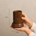 
Serene brown ceramic aroma lamp held in hands showing its compact size
