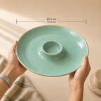 
Teal ceramic Solena dip platter held in hands showing 25.3 cm size with dimension line