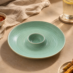 Teal ceramic Solena dip platter styled on a dining table with an elegant table setting